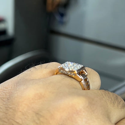 A man's hand holding a diamond ring with a solid gold band, featuring a prominent smaller diamonds along the band.