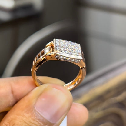 A man's hand holding a diamond ring with a solid gold band, featuring a prominent smaller diamonds along the band.