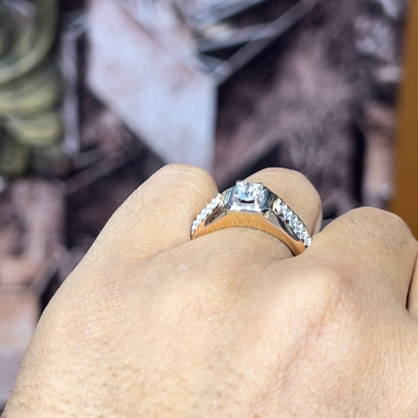 gold men's diamond ring with square solitaire and intricate lattice band detail shown on finger.