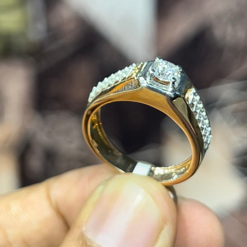 gold men's diamond ring with square solitaire and intricate lattice band detail shown on finger.