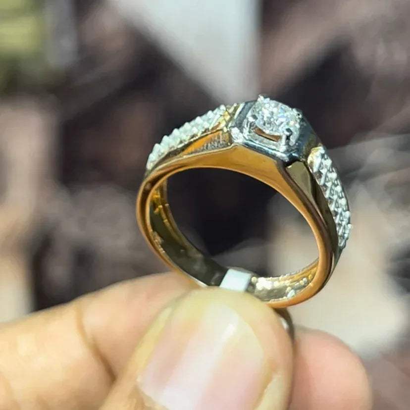 gold men's diamond ring with square solitaire and intricate lattice band detail shown on finger.