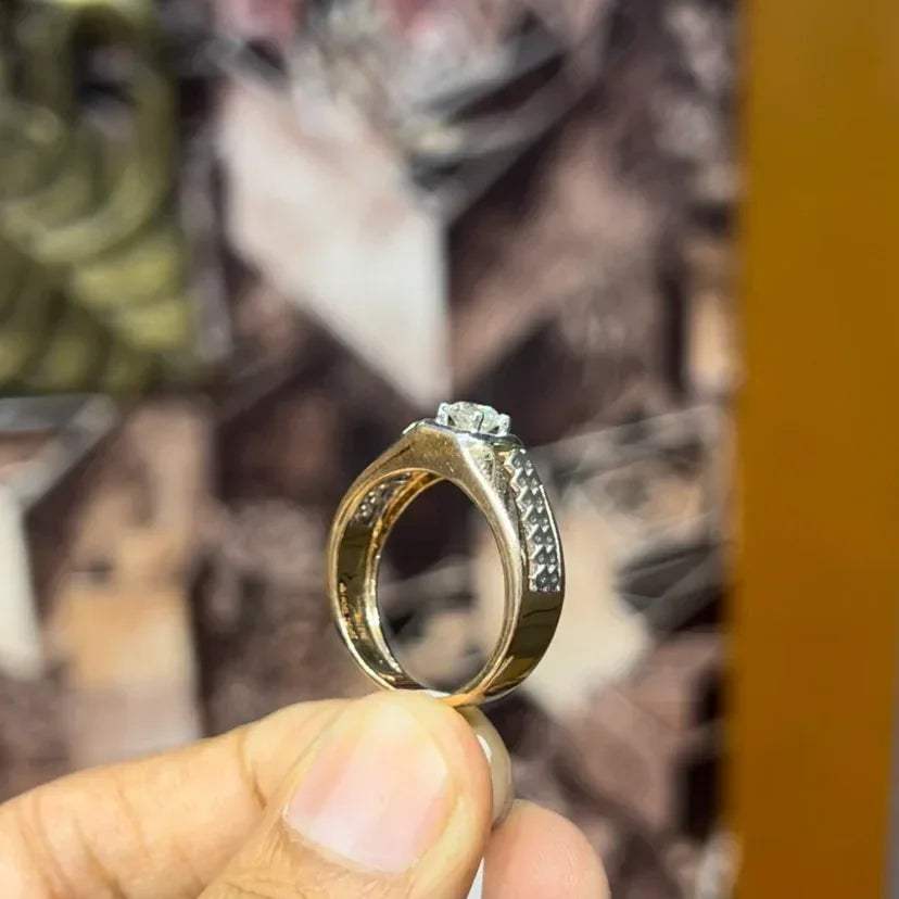 gold men's diamond ring with square solitaire and intricate lattice band detail shown on finger.