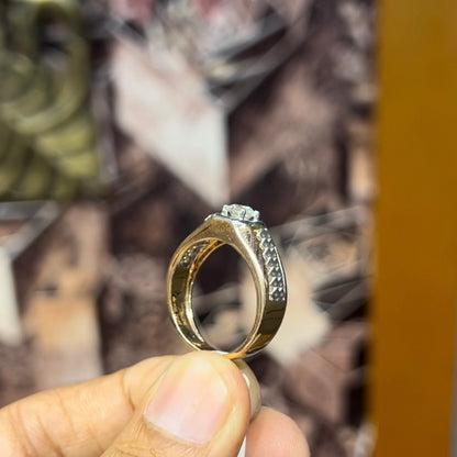 gold men's diamond ring with square solitaire and intricate lattice band detail shown on finger.