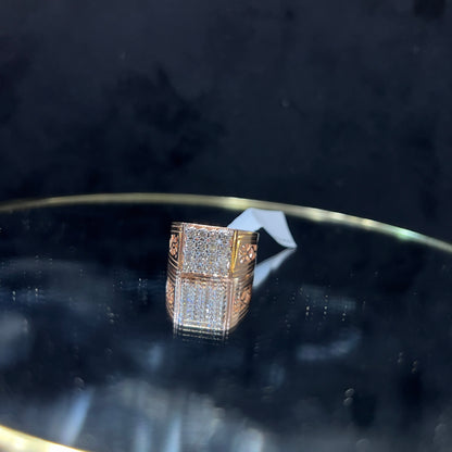 A gold band ring with smaller round cut diamonds is displaying on a reflective surface.