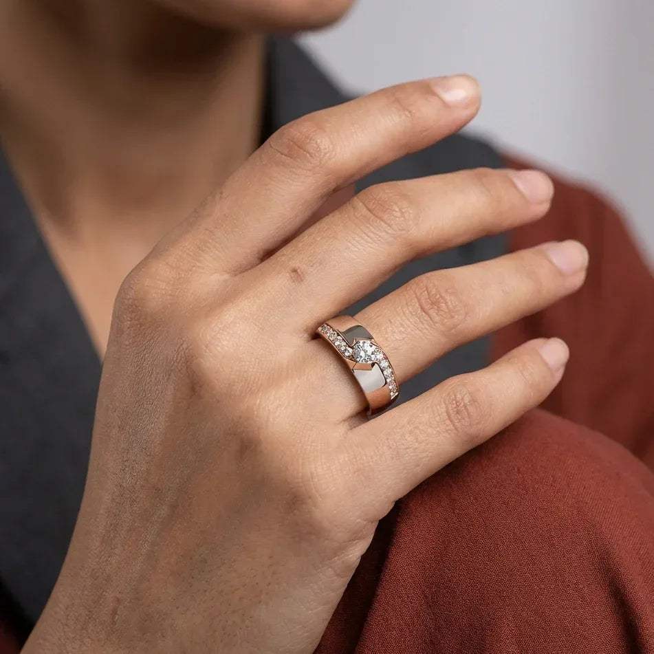 Close-up of a hand wearing a ring with a diamonds on a neutral background