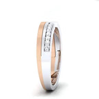 rose gold and white gold tone wedding band with diamond accents on a white background