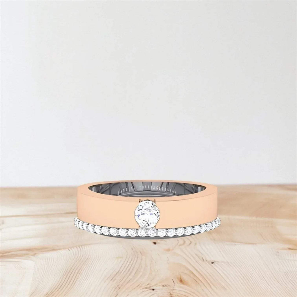 Rose gold ring with a diamond on a wooden surface