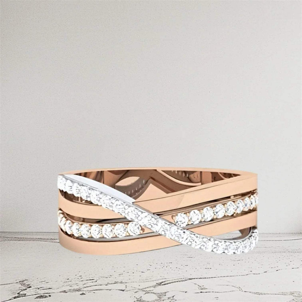 Rose gold and white gold ring with diamond accents on a light gray background.