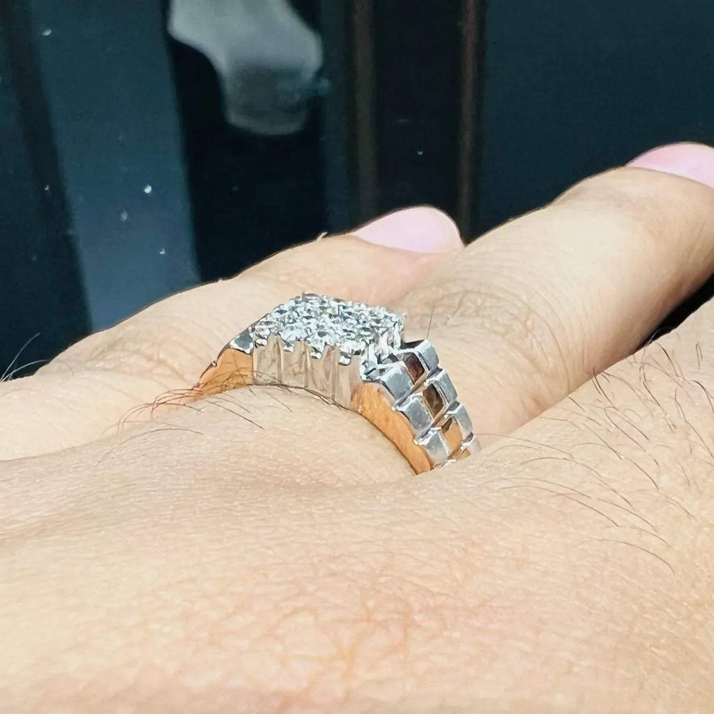 A man's hand displaying a gold diamond ring with a solid band and a small diamond inlay on the top surface.