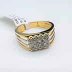 A gold band ring with smaller round-cut diamonds is displayed on a white surface.