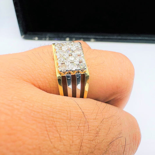 A man's hand displaying a gold band ring with smaller round-cut diamonds.