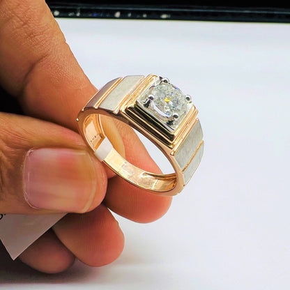 A man's hand holding a solitaire diamond ring with a gold band.
