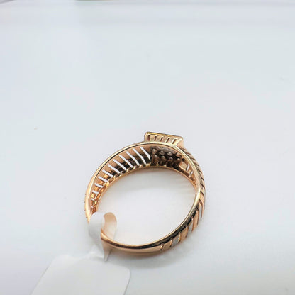 A top view of a gold diamond ring with round cut diamonds set in a square shape displayed on a white surface.