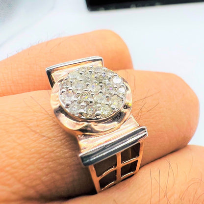 A man's hand displaying a gold band ring with round-cut diamonds set in the band.