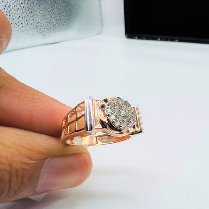 A man's hand displaying a gold band ring with round-cut diamonds set in the band.