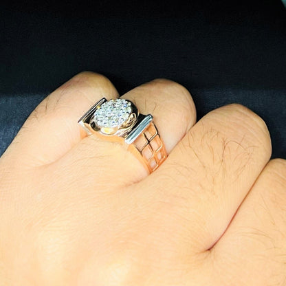 A man's hand displaying a gold band ring with round-cut diamonds set in the band.