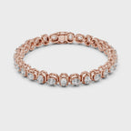 Rose gold tennis bracelet with real diamonds is rotating horizontally on a white surface.