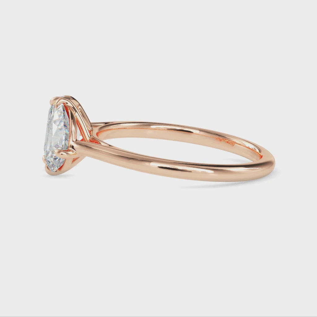 gold ring with two different shaped diamonds on a white background are displaying from 360 degree angle.