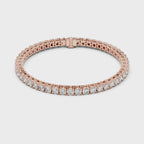 Rose gold bracelet with real diamonds is rotating parallel to the white surface.