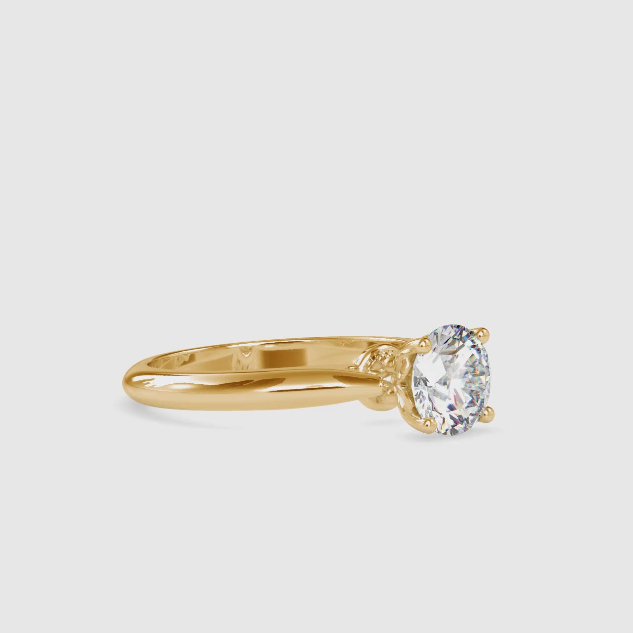 Gold ring with a solitaire lab grown diamond on a white background shown from 360 degree angle