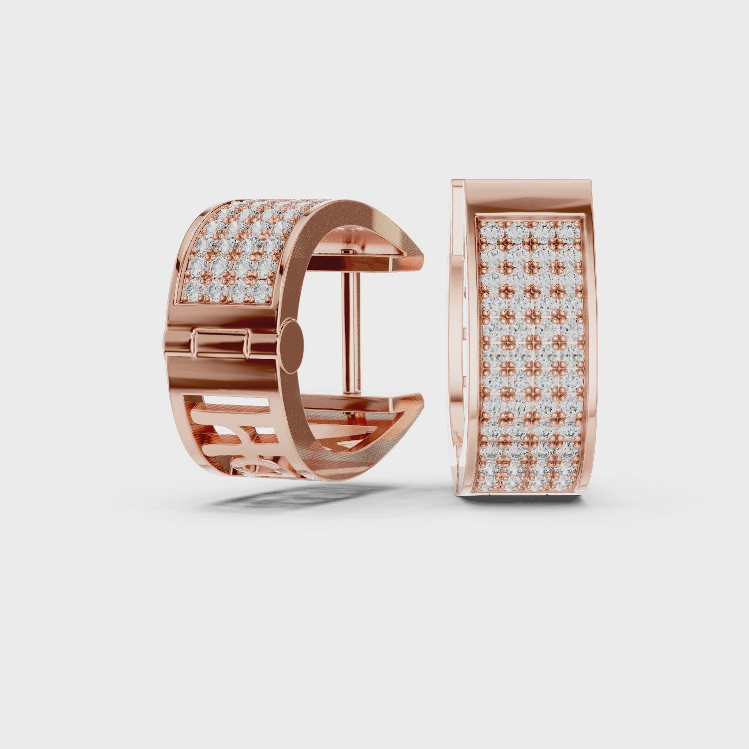 diamond hoop earrings are rotating 360 degree angle on a white surface.