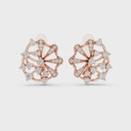 Rose gold earrings with real diamond accents are rotating horizontally on a white surface.