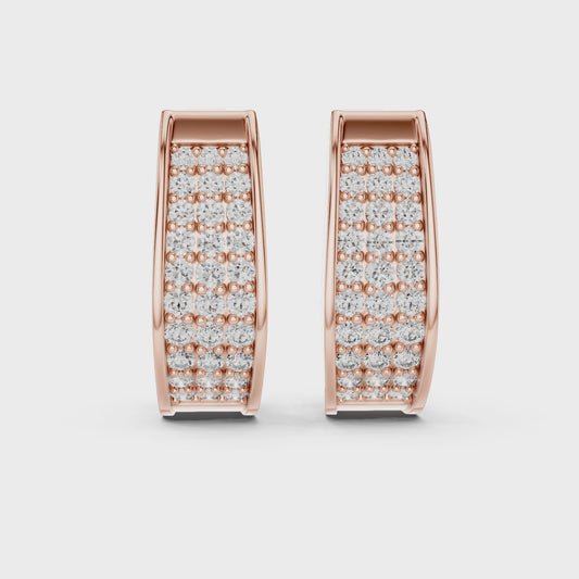 Rose gold earrings with diamonds set in pave setting is displaying on a white surface.