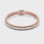 Rose gold bracelet with real diamond accents rotating parallel to the white surface.