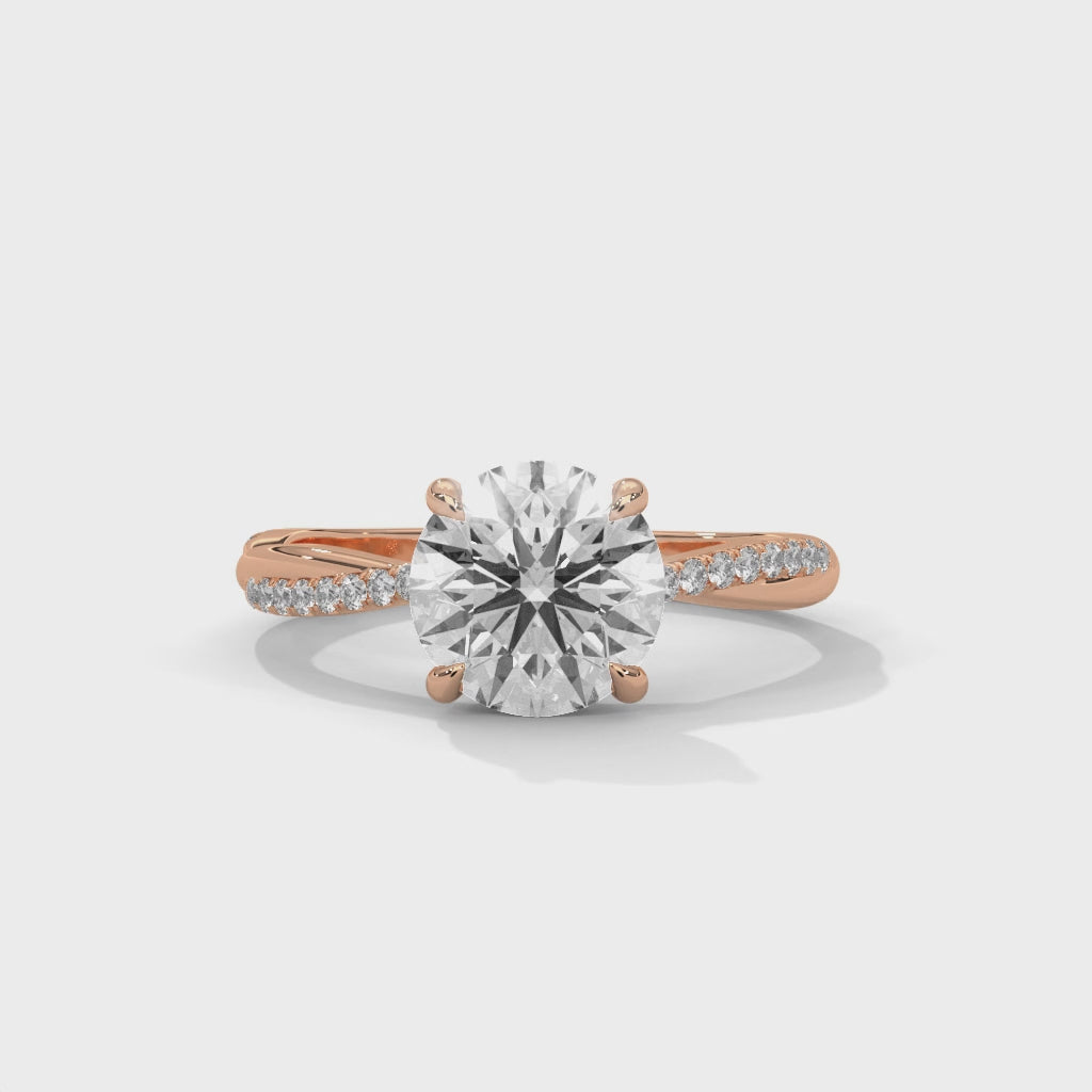 gold ring with a large diamond and smaller diamonds on the band against a white surface is displaying from 360 degree angle