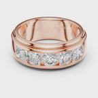 Rose gold ring with five round diamonds is rotating horizontally on a white surface, showing it from every angle.