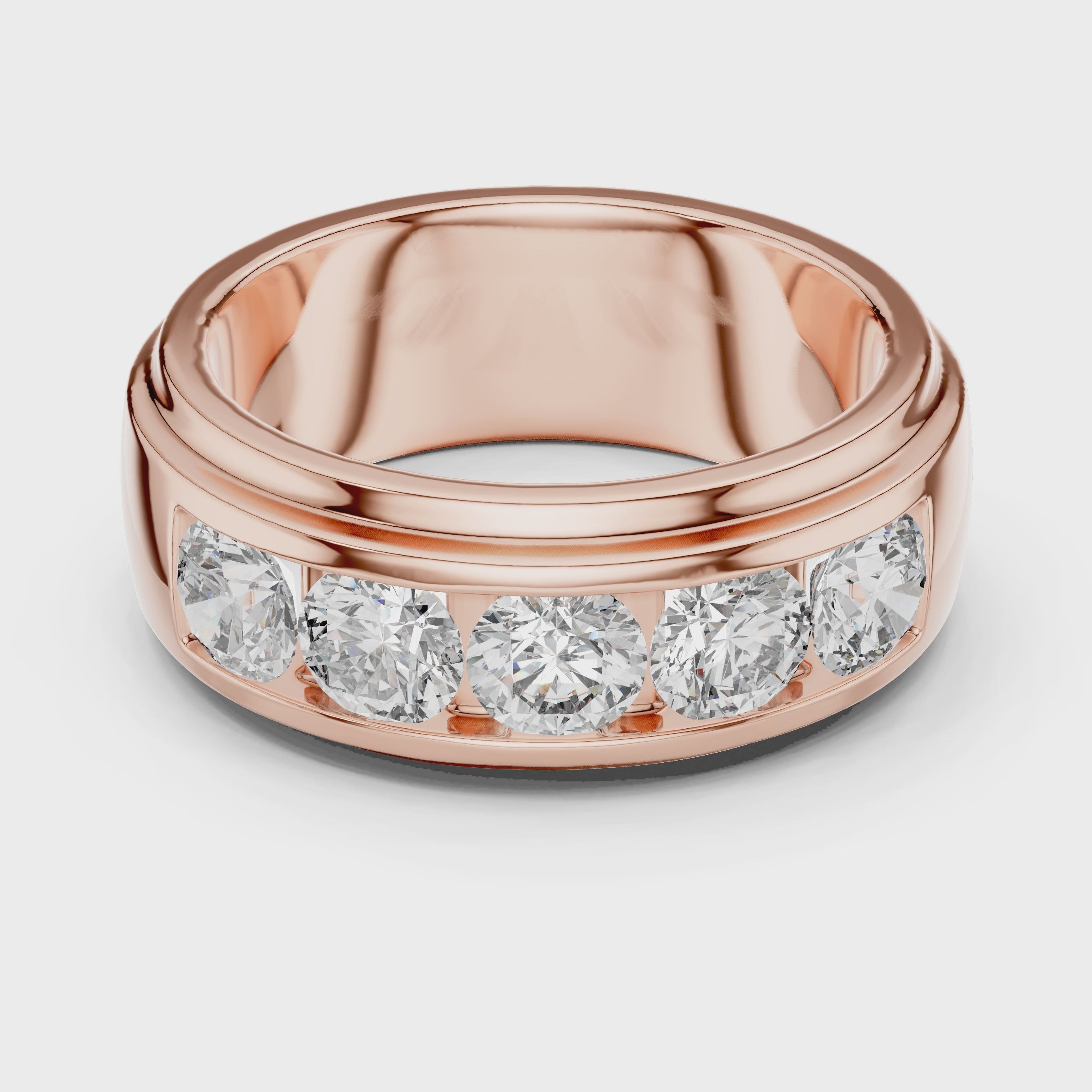 Rose gold ring with five round diamonds is rotating horizontally on a white surface, showing it from every angle.