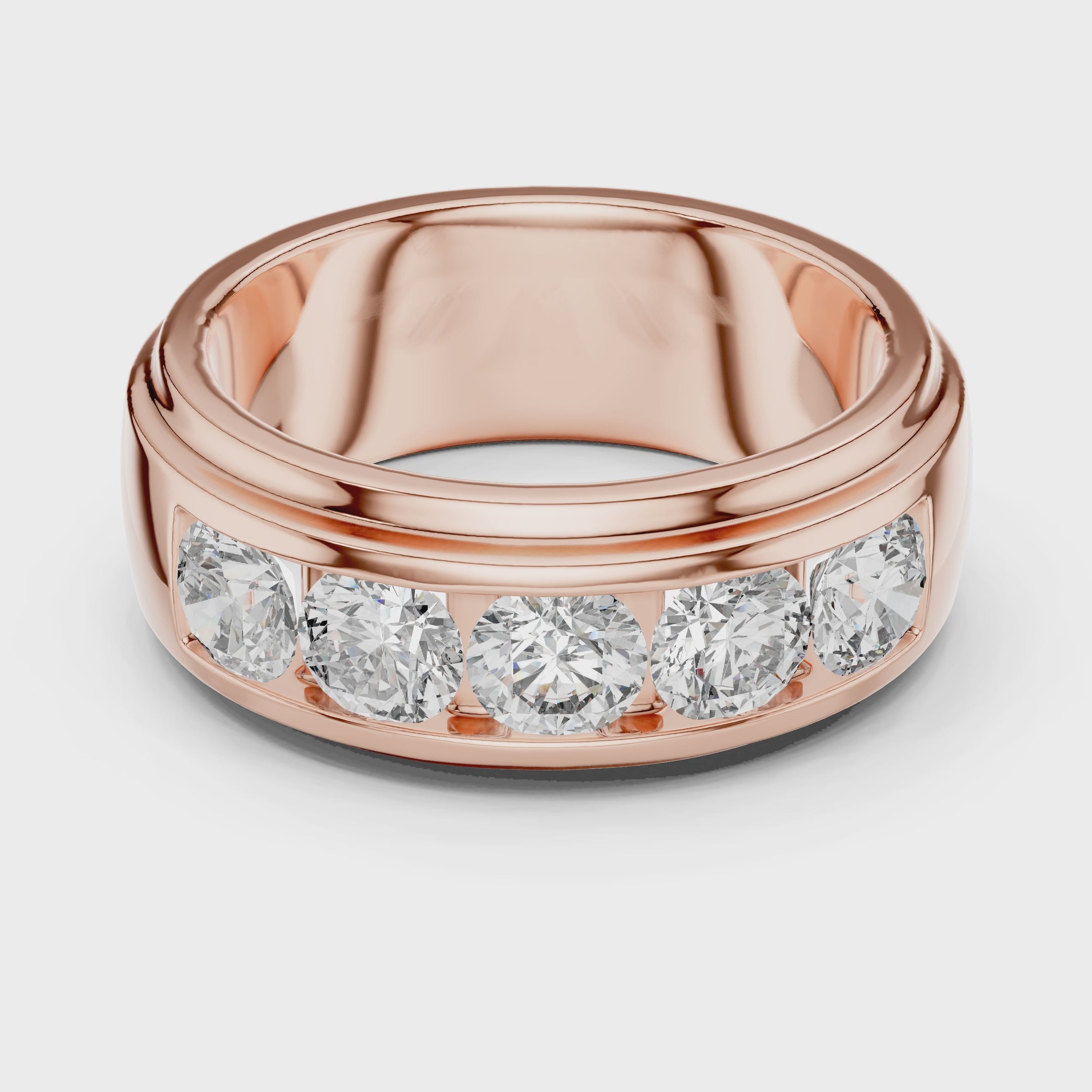 Rose gold ring with five round diamonds is rotating horizontally on a white surface, showing it from every angle.