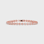 Gold bracelet with small lab grown diamonds on a white background, displayed from 360 degree angle.