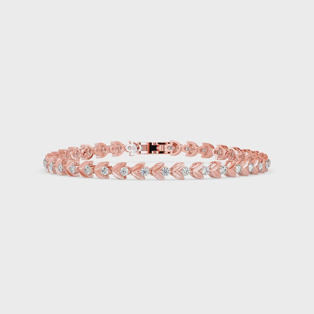 Gold bracelet with small lab grown diamonds on a white background, displayed from 360 degree angle.
