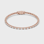 Rose gold and real diamonds bracelet on a white background rotating parallel to the surface.
