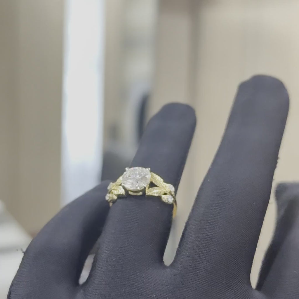 Gold ring with diamonds on a hand that is worn black gloves and tilting hands both sides to show the ring from every angle.