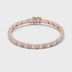 Rose gold bracelet with emerald cut real diamonds is rotating horizontally on the white surface.