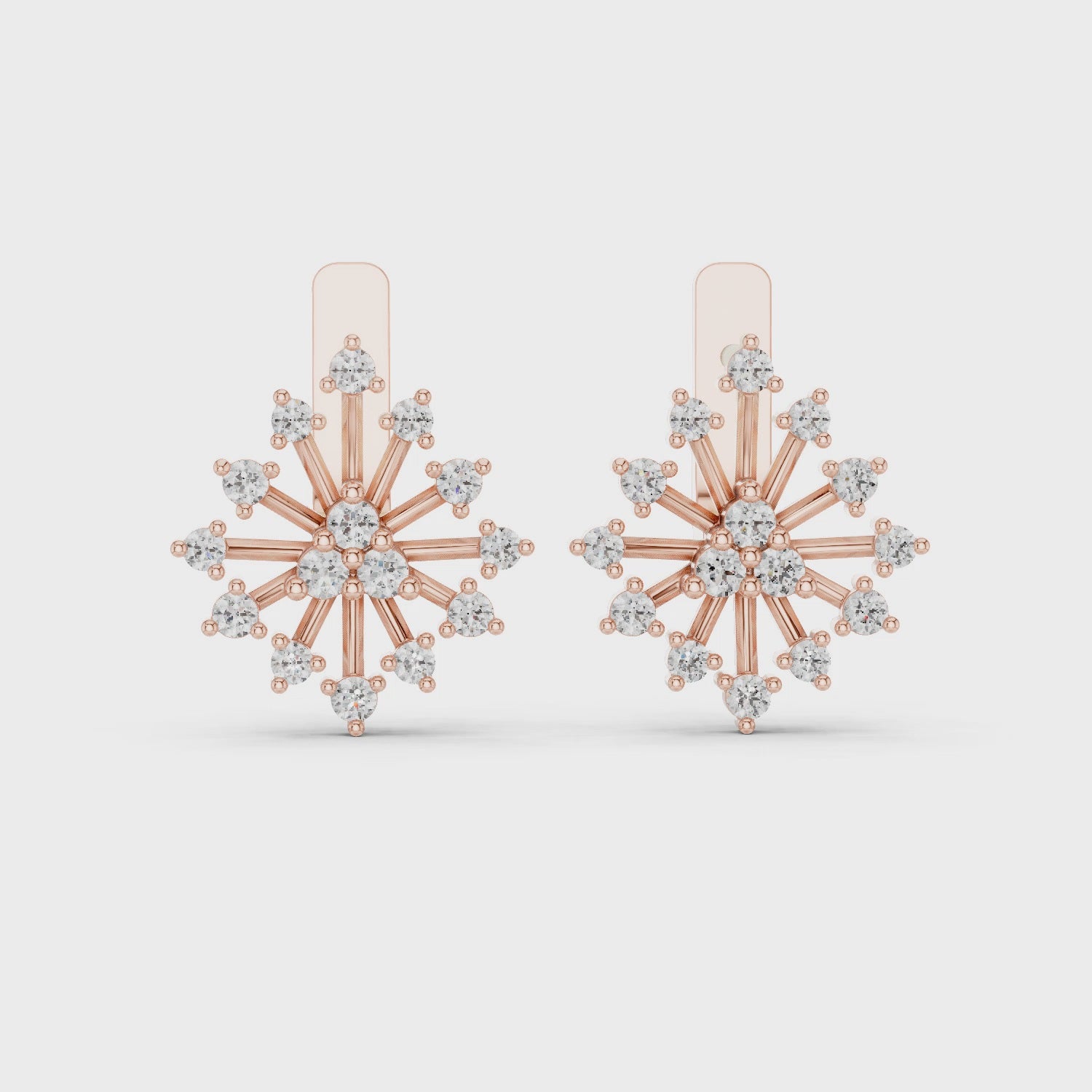 women's floral style diamond and gold earrings are shown from 360 degree angle against a white background.