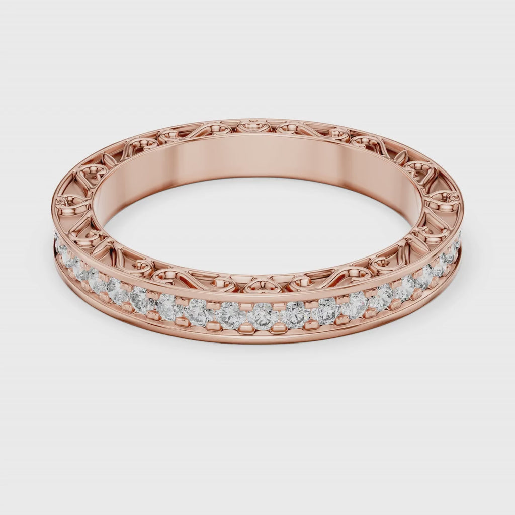 Rose gold ring with natural diamonds is rotating round on a white surface.