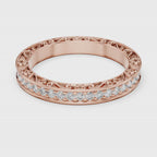 Rose gold ring with natural diamonds is rotating round on a white surface.