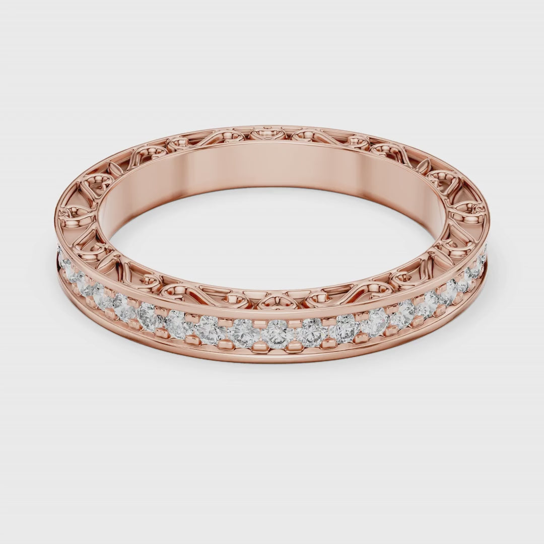 Rose gold ring with natural diamonds is rotating round on a white surface.