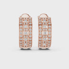 Rose gold hoop earrings with real diamond accents is rotating horizontally on a white surface.