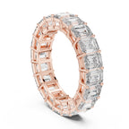 Rose gold ring with emerald-cut natural diamonds on a white background