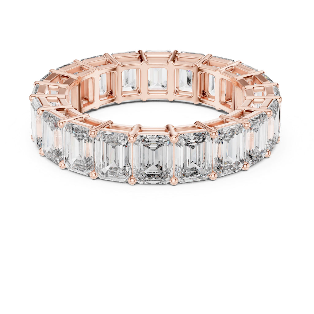 Rose gold ring with emerald-cut natural diamonds on a white background
