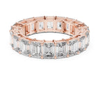 Rose gold ring with emerald-cut natural diamonds on a white background