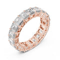 Rose gold ring with emerald-cut natural diamonds on a white background