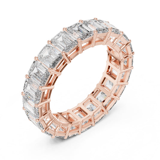 Rose gold ring with emerald-cut natural diamonds on a white background