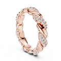 Rose gold ring with diamond accents on a white background