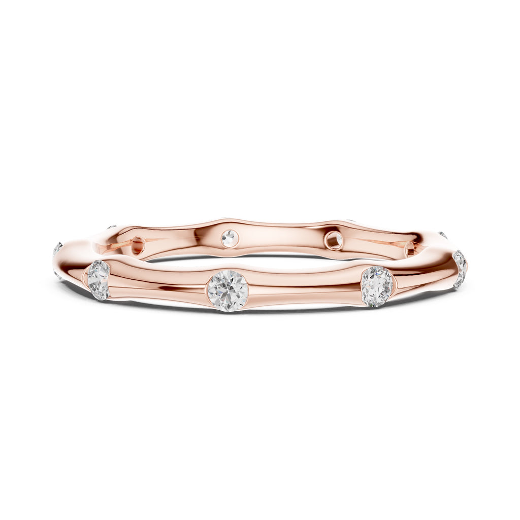 Rose gold ring with embedded diamonds on a white background