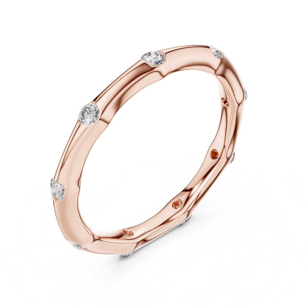 Rose gold ring with embedded diamonds on a white background